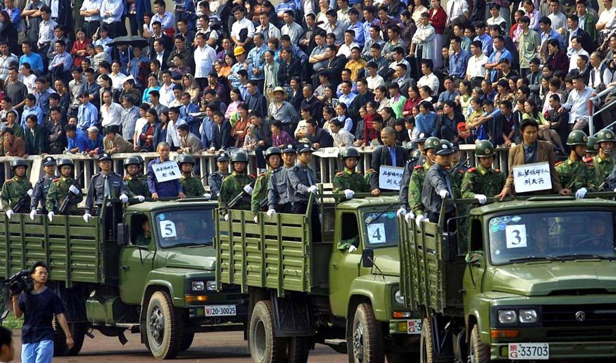 Trucks carrying condemned prisoners parade in fron Trucks carrying condemned prisoners parade in fron
